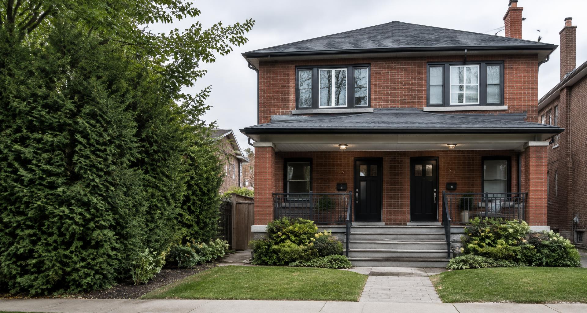 A brick duplex on a residential Toronto street